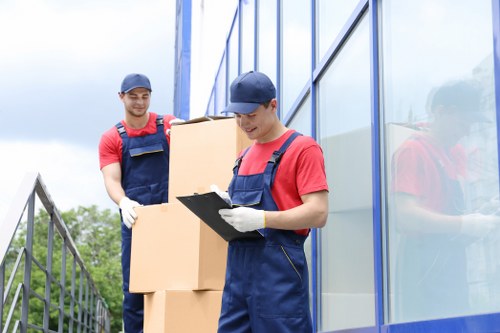 Professional movers organizing packed boxes for transport in Uxbridge
