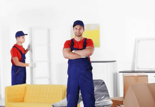 Removal team safely loading furniture during a house move