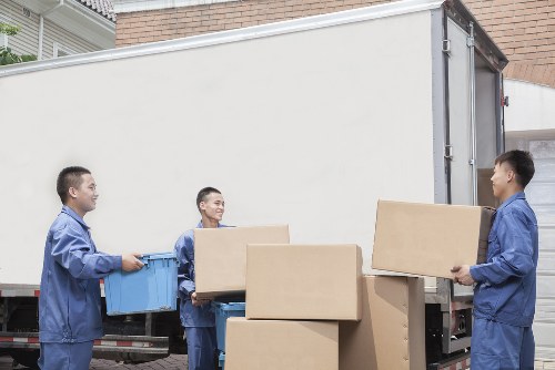 Removal service in Uxbridge loading carefully packed boxes into a van