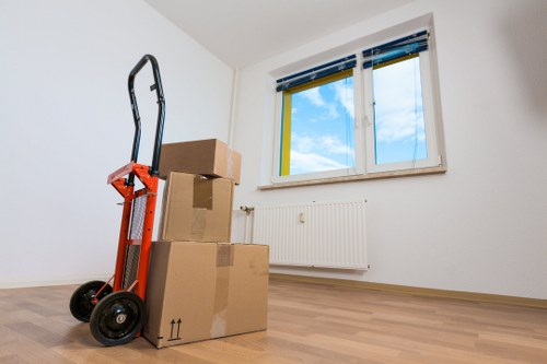 Local van driver loading household items for an Uxbridge move