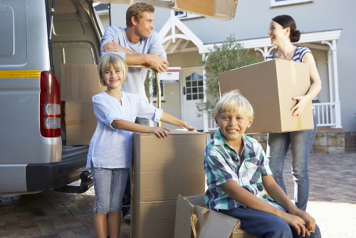 Experienced movers navigating stairs during piano removals in Uxbridge