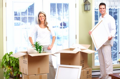 Trained movers carrying items through a house with care