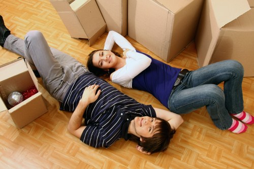 Removal team carrying furniture through a typical Uxbridge property