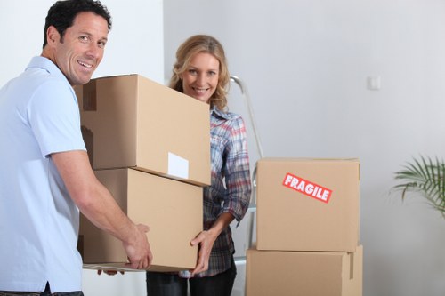 Team securing boxes inside a removal van for transport