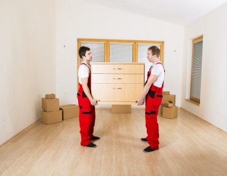 Loading household items into a removals vehicle