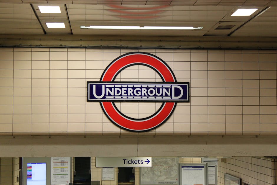 The image depicts an underground station platform at Uxbridge Tube Station UB8, with the curved ceiling typical of underground transit systems. The platform is illuminated by overhead lighting, and th